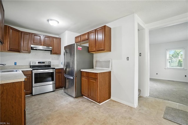 3559 Brest Ave, Norfolk, VA 23509 - kitchen featuring appliances with stainless steel finishes, under cabinet range hood, light countertops, and light flooring