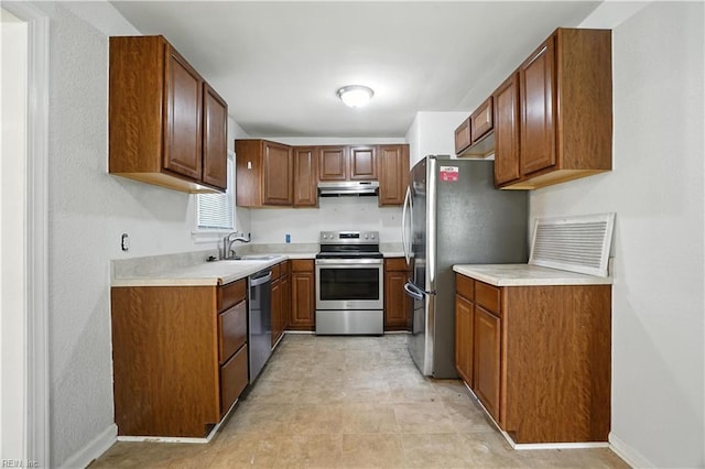 3559 Brest Ave, Norfolk, VA 23509 - kitchen featuring stainless steel appliances, under cabinet range hood, brown cabinetry, and light countertops