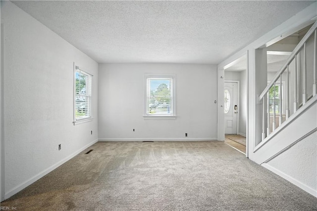 3559 Brest Ave, Norfolk, VA 23509 - carpeted spare room featuring plenty of natural light, a textured ceiling, and stairs