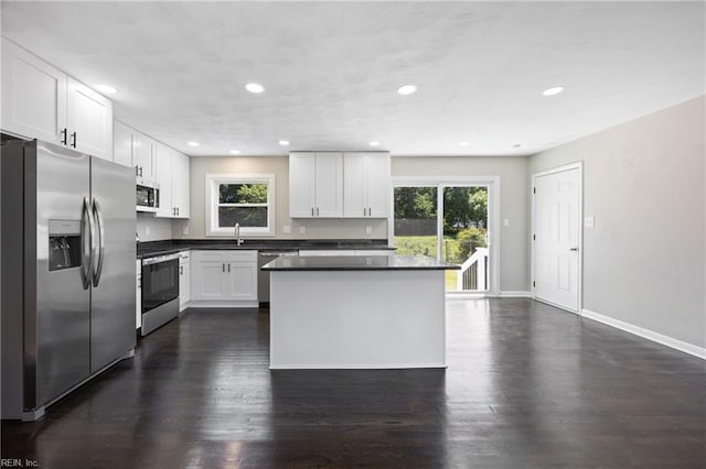 703 Terrace Dr, Newport News, VA 23601 - kitchen with stainless steel appliances, plenty of natural light, white cabinetry, dark wood finished floors, and recessed lighting