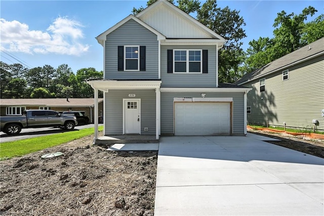 2152 Millville Rd, Chesapeake, VA 23323 - view of front facade with an attached garage, concrete driveway, covered porch, and board and batten siding