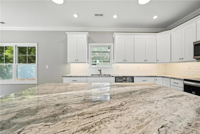 2152 Millville Rd, Chesapeake, VA 23323 - kitchen with stainless steel appliances, healthy amount of natural light, light stone counters, ornamental molding, and recessed lighting
