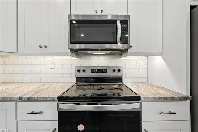 2152 Millville Rd, Chesapeake, VA 23323 - kitchen with appliances with stainless steel finishes, backsplash, light stone counters, and white cabinetry