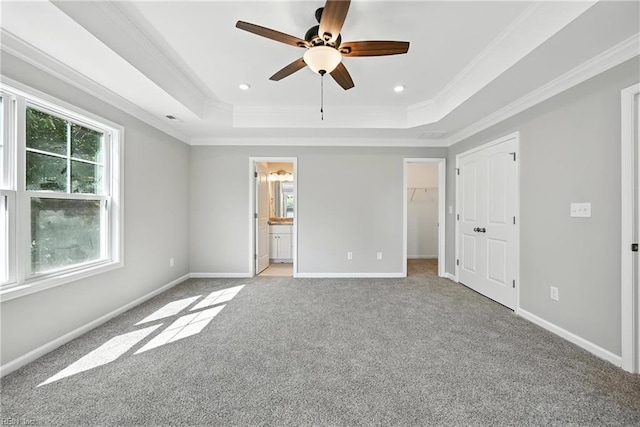 2152 Millville Rd, Chesapeake, VA 23323 - unfurnished bedroom with a tray ceiling, light colored carpet, ornamental molding, a spacious closet, and connected bathroom