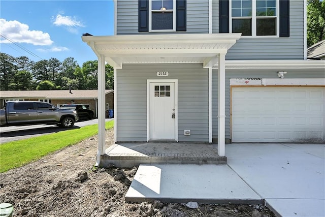2152 Millville Rd, Chesapeake, VA 23323 - property entrance with an attached garage, driveway, and covered porch