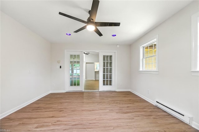 1409 Amberley Forest Rd, Virginia Beach, VA 23453 - spare room featuring a baseboard radiator, a ceiling fan, healthy amount of natural light, and light wood-type flooring