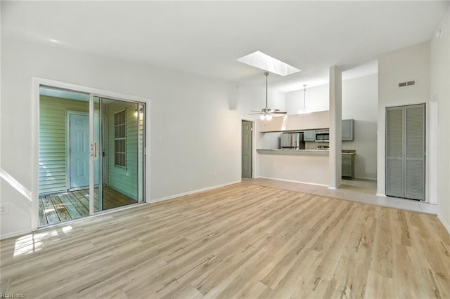 647 Crows Nest Ct, Virginia Beach, VA 23462 - unfurnished living room with a skylight, light wood-type flooring, a towering ceiling, and ceiling fan