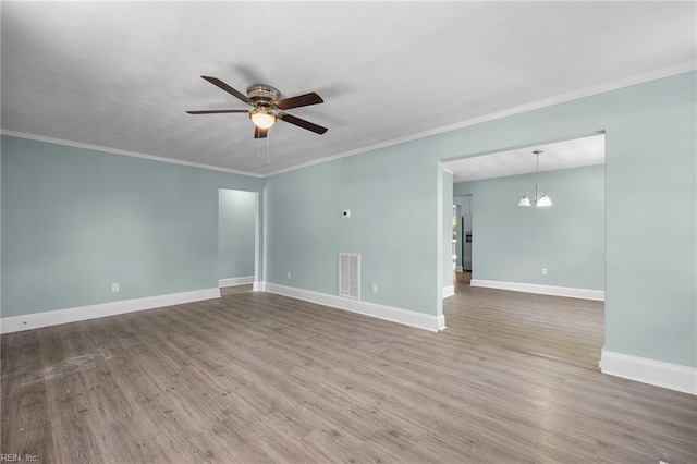 1003 Douglas Ave, Portsmouth, VA 23707 - unfurnished room featuring ceiling fan, wood finished floors, ornamental molding, and a chandelier