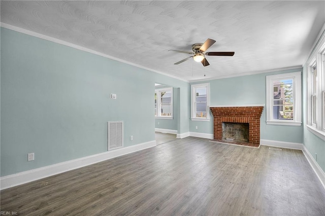 1003 Douglas Ave, Portsmouth, VA 23707 - unfurnished living room with a ceiling fan, wood finished floors, a brick fireplace, and ornamental molding