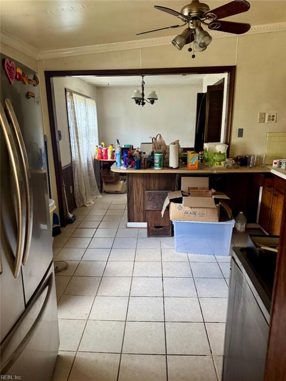 2609 Harling Dr, Chesapeake, VA 23325 - kitchen with freestanding refrigerator, light tile patterned floors, a ceiling fan, ornamental molding, and a peninsula