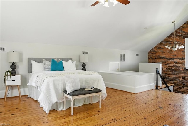 227 N Saratoga St, Suffolk, VA 23434 - bedroom with hardwood / wood-style flooring, lofted ceiling, a ceiling fan, and brick wall
