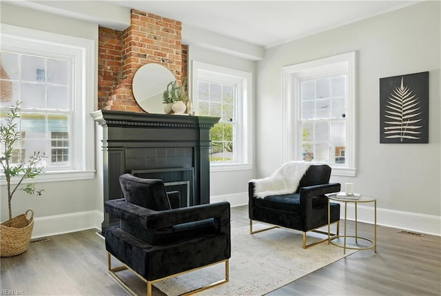 227 N Saratoga St, Suffolk, VA 23434 - living area with wood finished floors and a brick fireplace