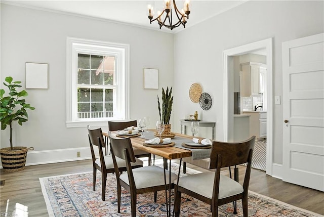 227 N Saratoga St, Suffolk, VA 23434 - dining room featuring wood finished floors, a chandelier, and ornamental molding