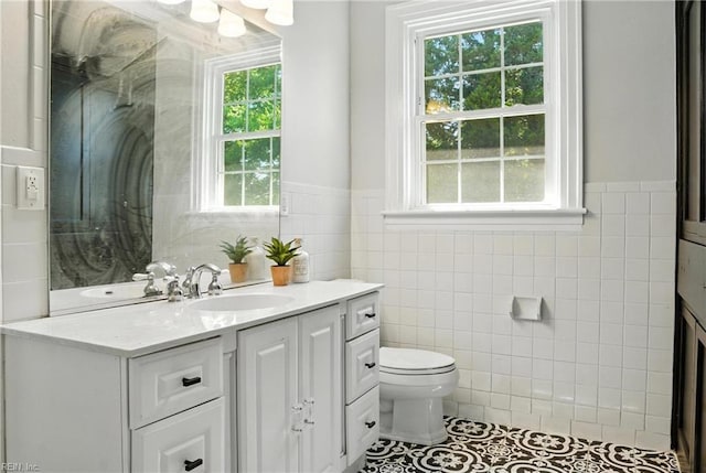 227 N Saratoga St, Suffolk, VA 23434 - full bathroom featuring tile walls, vanity, healthy amount of natural light, wainscoting, and tile patterned floors