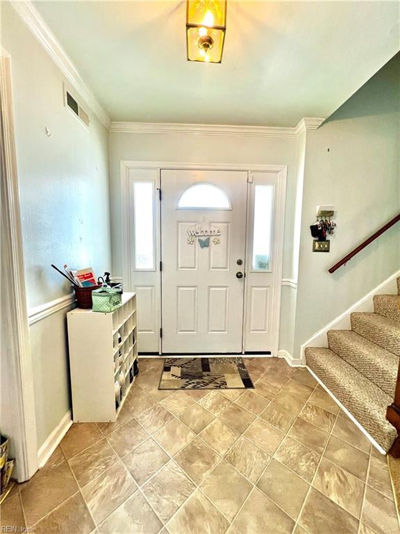 600 Cambria Ct, Virginia Beach, VA 23455 - foyer with healthy amount of natural light, ornamental molding, and stairway