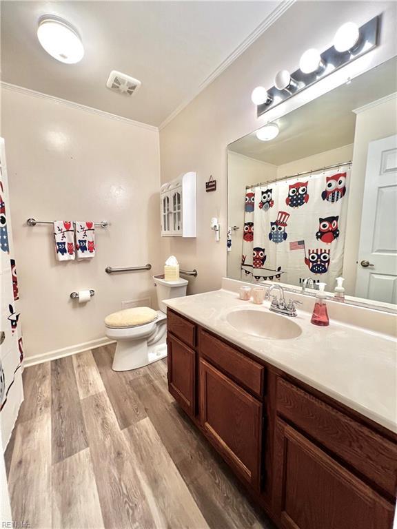 600 Cambria Ct, Virginia Beach, VA 23455 - full bathroom featuring crown molding, vanity, wood finished floors, and curtained shower