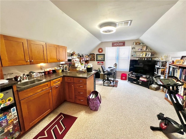 600 Cambria Ct, Virginia Beach, VA 23455 - kitchen featuring light colored carpet, lofted ceiling, brown cabinets, and dark countertops