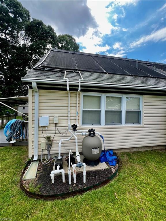 600 Cambria Ct, Virginia Beach, VA 23455 - rear view of property featuring roof mounted solar panels, a lawn, and a shingled roof