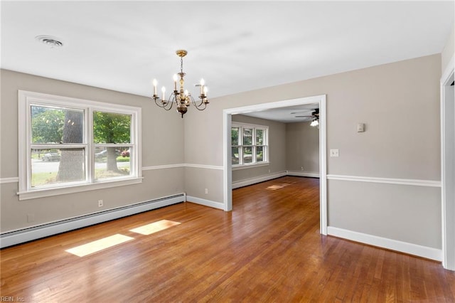 416 N Broad St, Suffolk, VA 23434 - unfurnished room with a chandelier, healthy amount of natural light, wood finished floors, and baseboard heating