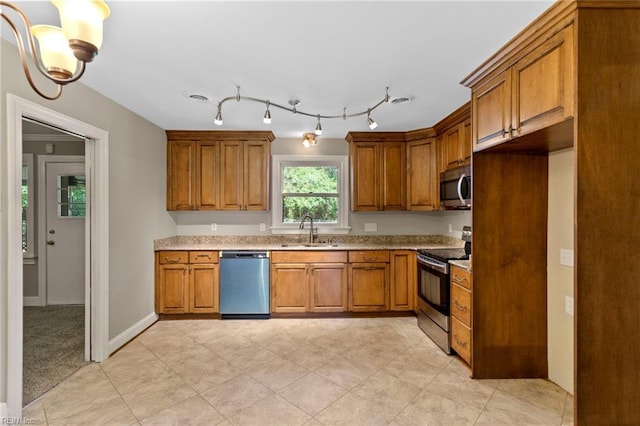 416 N Broad St, Suffolk, VA 23434 - kitchen featuring appliances with stainless steel finishes, brown cabinets, and light tile patterned flooring