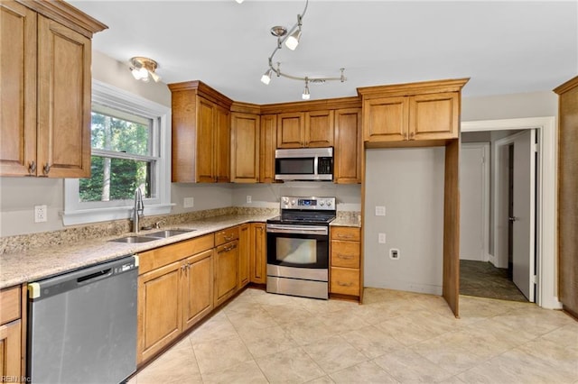 416 N Broad St, Suffolk, VA 23434 - kitchen featuring stainless steel appliances, brown cabinetry, light tile patterned flooring, and light stone counters