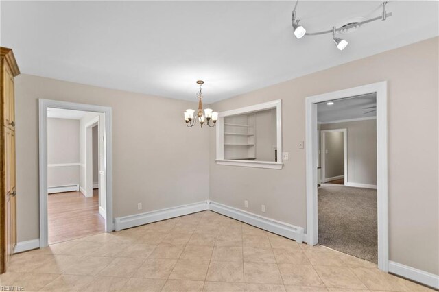 416 N Broad St, Suffolk, VA 23434 - unfurnished room featuring a baseboard radiator and a chandelier