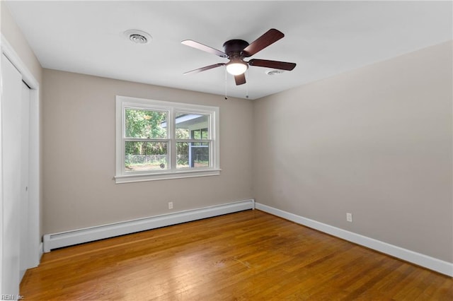 416 N Broad St, Suffolk, VA 23434 - unfurnished bedroom featuring a baseboard heating unit, wood finished floors, a closet, and ceiling fan
