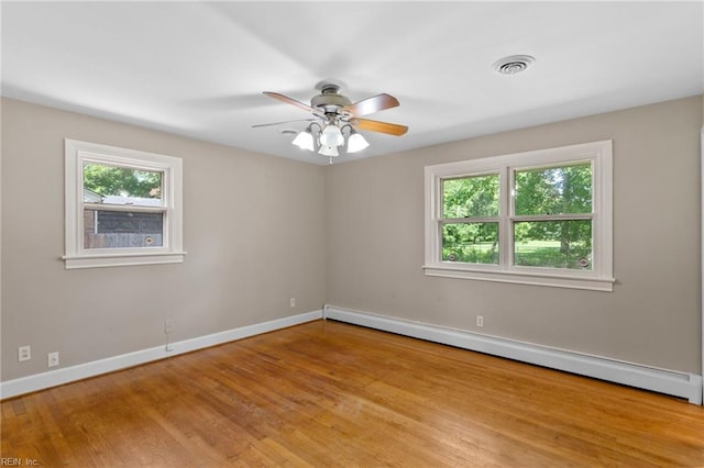 416 N Broad St, Suffolk, VA 23434 - unfurnished room with a baseboard heating unit, light wood-style flooring, and a ceiling fan