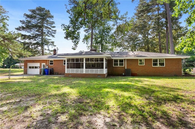 416 N Broad St, Suffolk, VA 23434 - rear view of house featuring a garage, a sunroom, crawl space, and brick siding