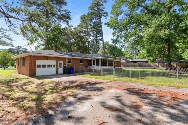 416 N Broad St, Suffolk, VA 23434 - ranch-style house with asphalt driveway, an attached garage, brick siding, and a chimney