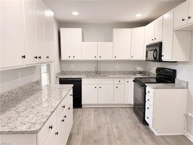 200 W Ocean Ave, Norfolk, VA 23503 - kitchen featuring black appliances, light wood-style flooring, white cabinets, light stone countertops, and recessed lighting