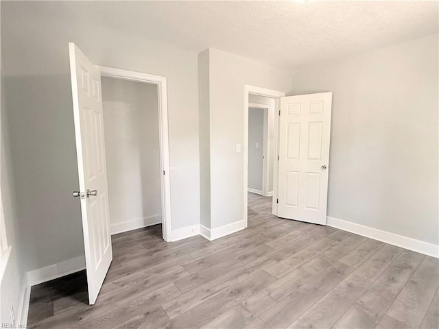 200 W Ocean Ave, Norfolk, VA 23503 - unfurnished bedroom featuring light wood finished floors and a textured ceiling