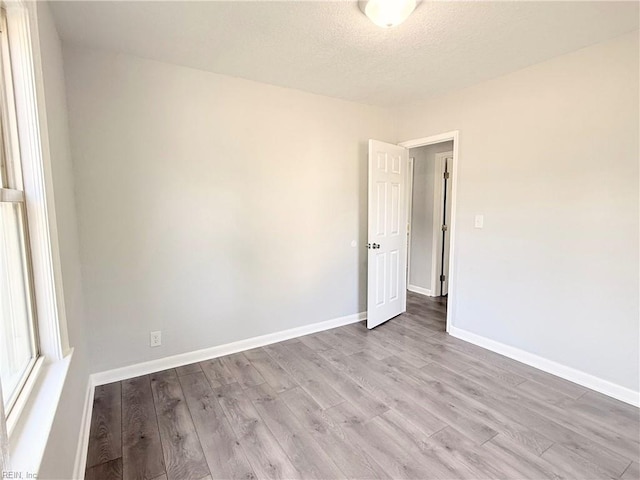 200 W Ocean Ave, Norfolk, VA 23503 - empty room with wood finished floors and a textured ceiling