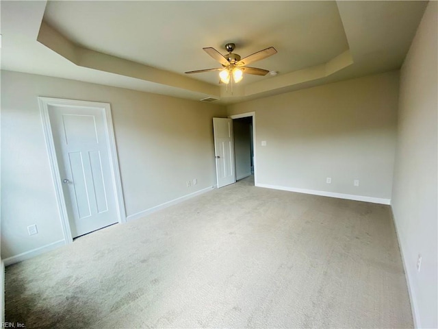 1400 Winslow Ave, Chesapeake, VA 23323 - empty room featuring a tray ceiling, carpet, and a ceiling fan