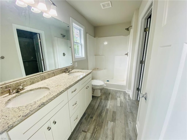 1400 Winslow Ave, Chesapeake, VA 23323 - bathroom with a walk in shower, wood finished floors, and double vanity