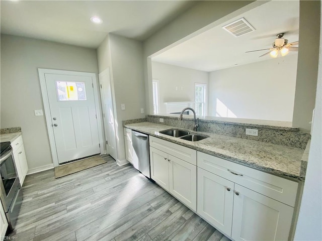 1400 Winslow Ave, Chesapeake, VA 23323 - kitchen with stainless steel appliances, light wood-type flooring, light stone countertops, white cabinets, and a ceiling fan
