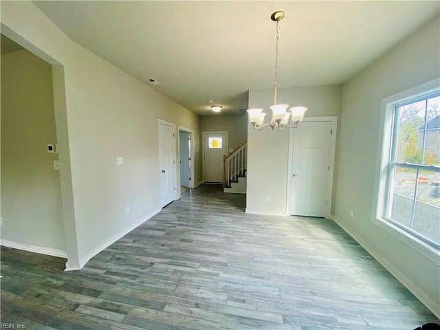 1400 Winslow Ave, Chesapeake, VA 23323 - unfurnished dining area with wood finished floors, a chandelier, and stairs