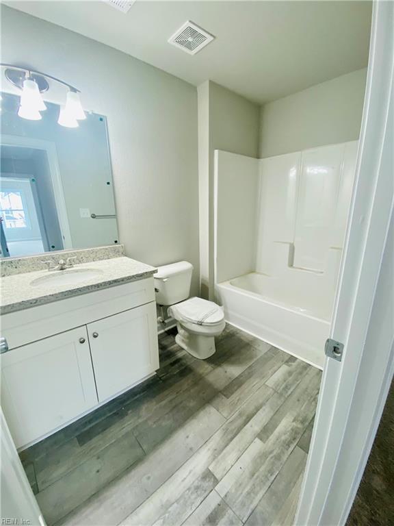 1400 Winslow Ave, Chesapeake, VA 23323 - bathroom featuring vanity, wood finished floors, and tub / shower combination