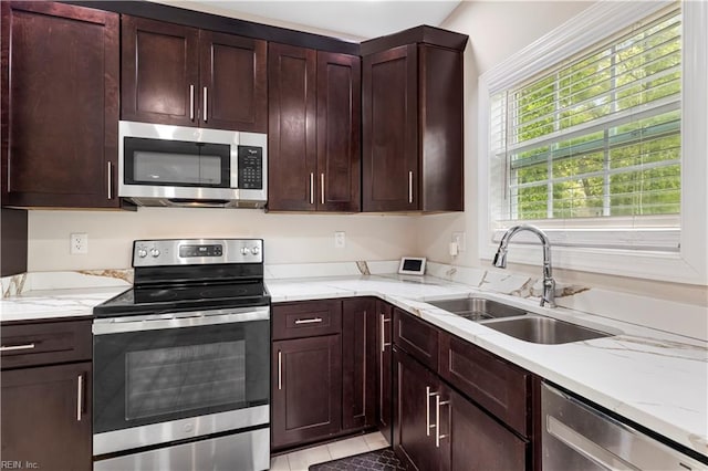 316 A Pocahontas Ave, Franklin, VA 23851 - kitchen with appliances with stainless steel finishes, light stone counters, dark brown cabinets, and light tile patterned floors