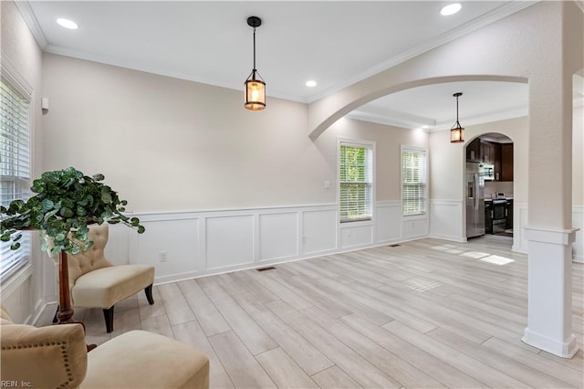 316 A Pocahontas Ave, Franklin, VA 23851 - living area with arched walkways, ornamental molding, light wood finished floors, a wainscoted wall, and recessed lighting