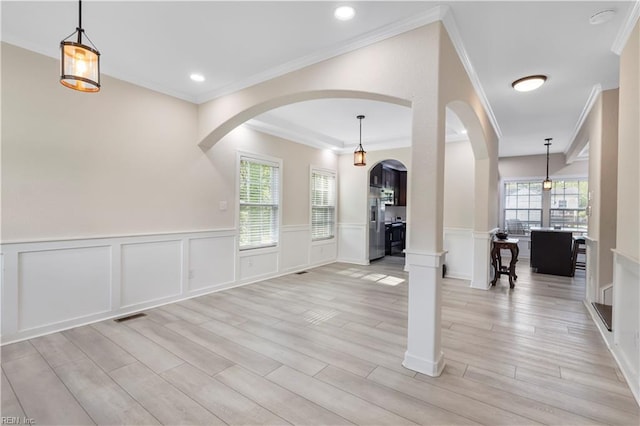 316 A Pocahontas Ave, Franklin, VA 23851 - entryway featuring arched walkways, crown molding, light wood-style floors, a decorative wall, and wainscoting