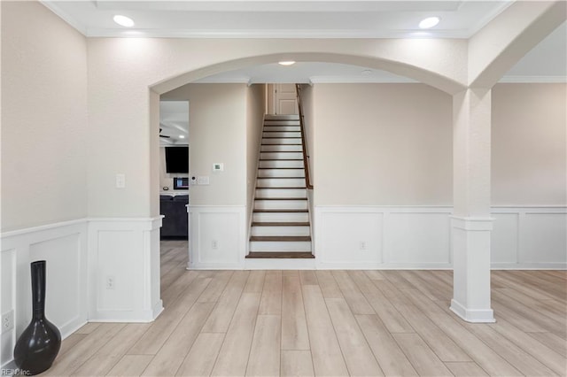 316 A Pocahontas Ave, Franklin, VA 23851 - stairway with crown molding, wood finished floors, wainscoting, a decorative wall, and arched walkways