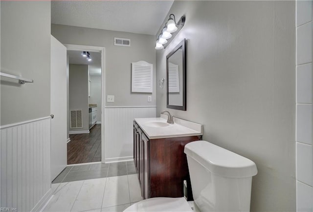 3856 Lasalle Dr Unit 107, Virginia Beach, VA 23453 - bathroom with vanity, wainscoting, and tile patterned flooring