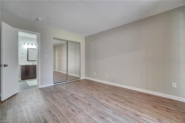 3856 Lasalle Dr Unit 107, Virginia Beach, VA 23453 - unfurnished bedroom featuring light wood finished floors, a closet, and connected bathroom