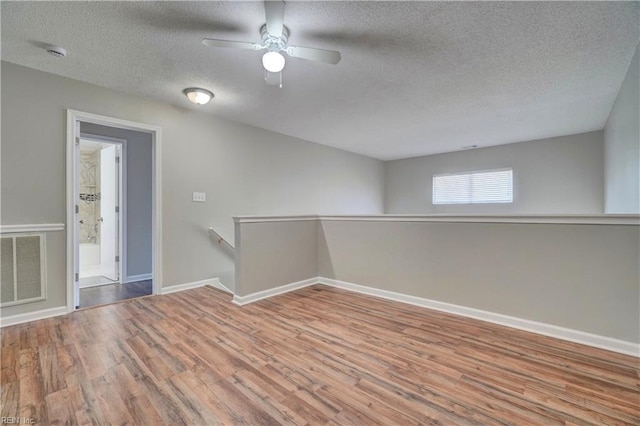 3856 Lasalle Dr Unit 107, Virginia Beach, VA 23453 - empty room featuring a textured ceiling, wood finished floors, a ceiling fan, and a smoke detector