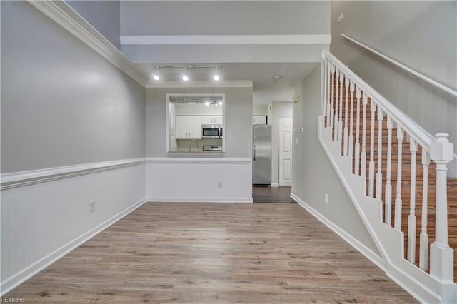 3856 Lasalle Dr Unit 107, Virginia Beach, VA 23453 - spare room featuring light wood-style floors, stairs, ornamental molding, and a wainscoted wall