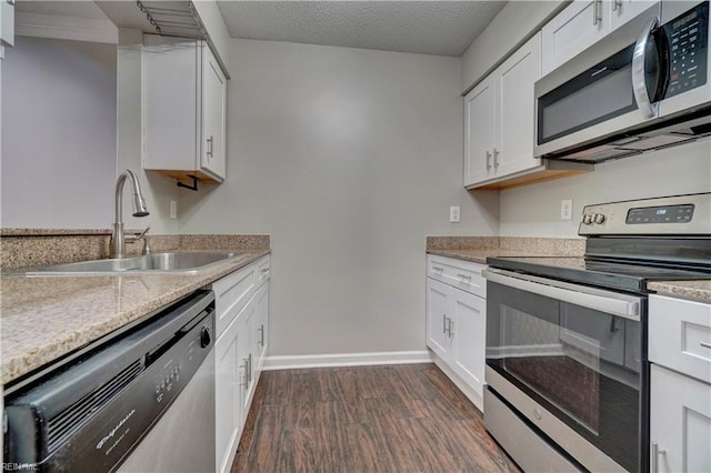 3856 Lasalle Dr Unit 107, Virginia Beach, VA 23453 - kitchen with stainless steel appliances, dark wood-style floors, white cabinets, light stone counters, and a textured ceiling