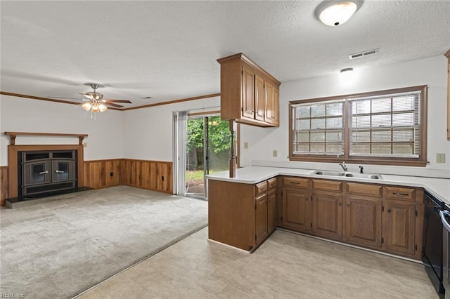 2024 Sarahs Cove Dr, Hayes, VA 23072 - kitchen featuring light countertops, a wainscoted wall, a ceiling fan, open floor plan, and brown cabinets