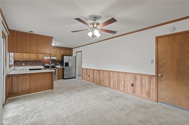 2024 Sarahs Cove Dr, Hayes, VA 23072 - kitchen featuring appliances with stainless steel finishes, brown cabinetry, a ceiling fan, extractor fan, and a peninsula