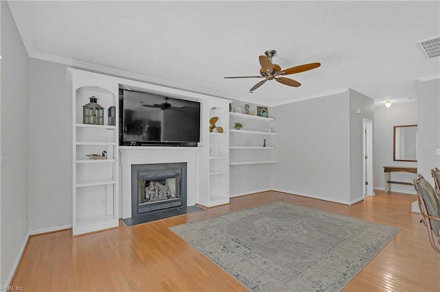 2024 Sarahs Cove Dr, Hayes, VA 23072 - living area featuring a ceiling fan, wood finished floors, a fireplace, ornamental molding, and built in shelves